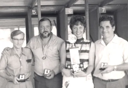 Four Wakehurst Pistol Club members holding their medals