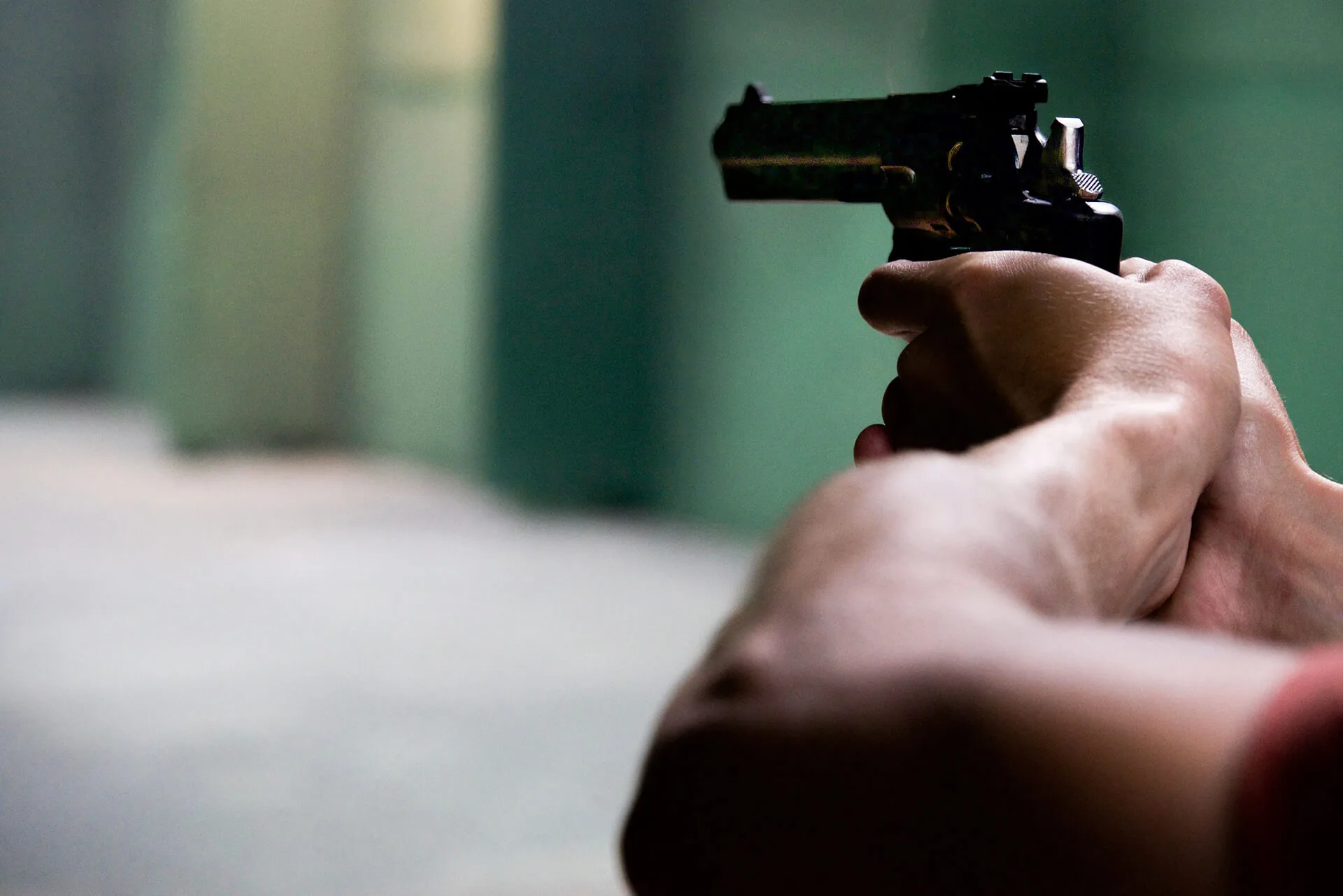 A target pistol held in the aim